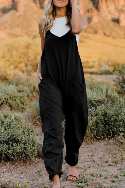 Trendsi Double Take full-size sleeveless V-neck jumpsuit with pockets, black fabric, and a fitted waist, shown on a model.