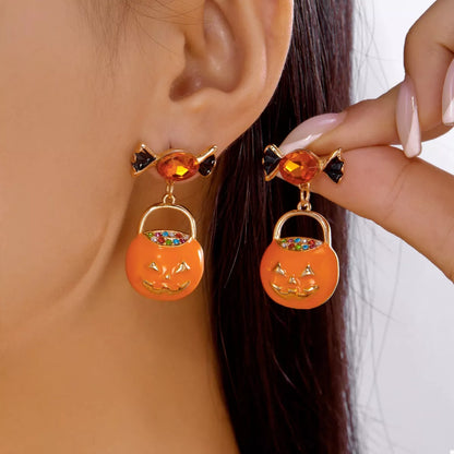 Halloween rhinestone pumpkin dangle earrings with sparkling details and metallic hooks, perfect for festive fall accessories.