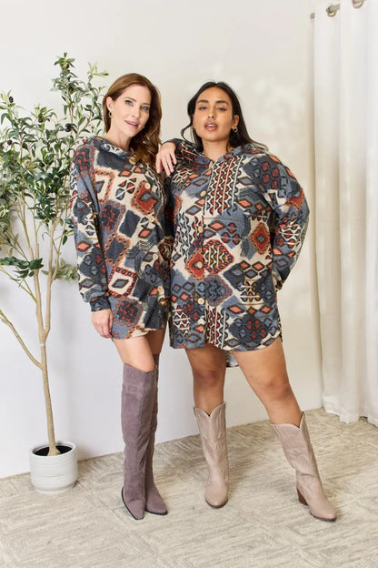 Heimish full-size printed button-up hooded jacket with colorful design, casual style, and front pockets, perfect for outdoor wear.