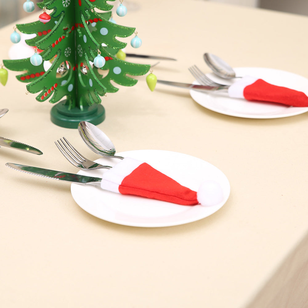 Set of 20 Christmas hat-shaped cutlery holders by Trendsi, festive red and green fabric with holiday patterns.