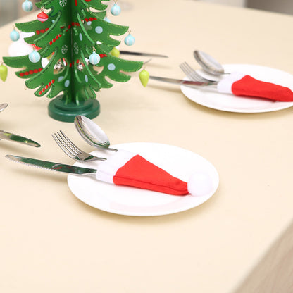 Set of 20 Christmas hat-shaped cutlery holders by Trendsi, festive red and green fabric with holiday patterns.
