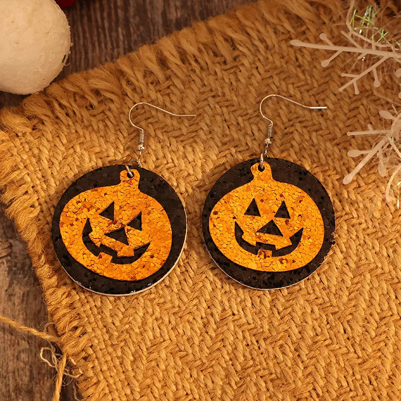PU leather pumpkin earrings by Trendsi, featuring orange pumpkin-shaped dangles with gold accents, perfect for fall accessories.