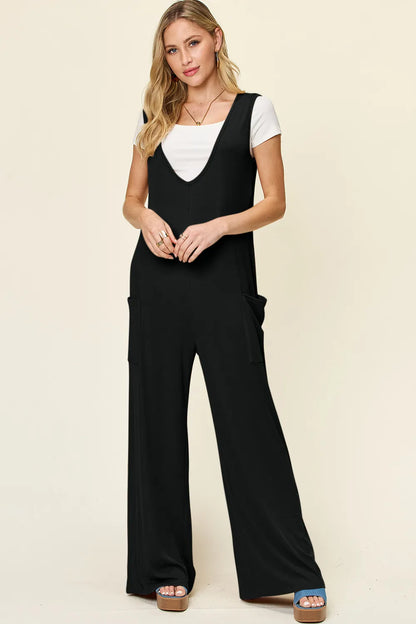 Plus size Trendsi Double Take sleeveless wide leg jumpsuit with pockets, full length, casual style, in a neutral fabric.