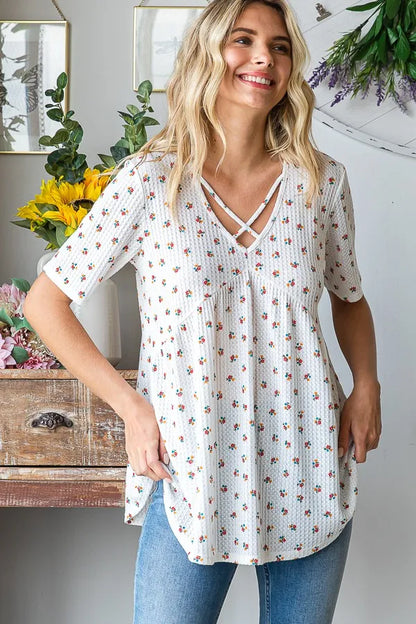 Heimish full size crisscross ditsy floral babydoll top with plus size fit, featuring a feminine floral pattern and relaxed fit.