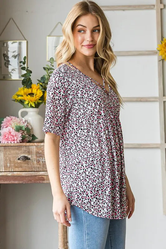 Plus size Heimish short sleeve crisscross animal babydoll top with a relaxed fit, featuring a stylish animal print design.