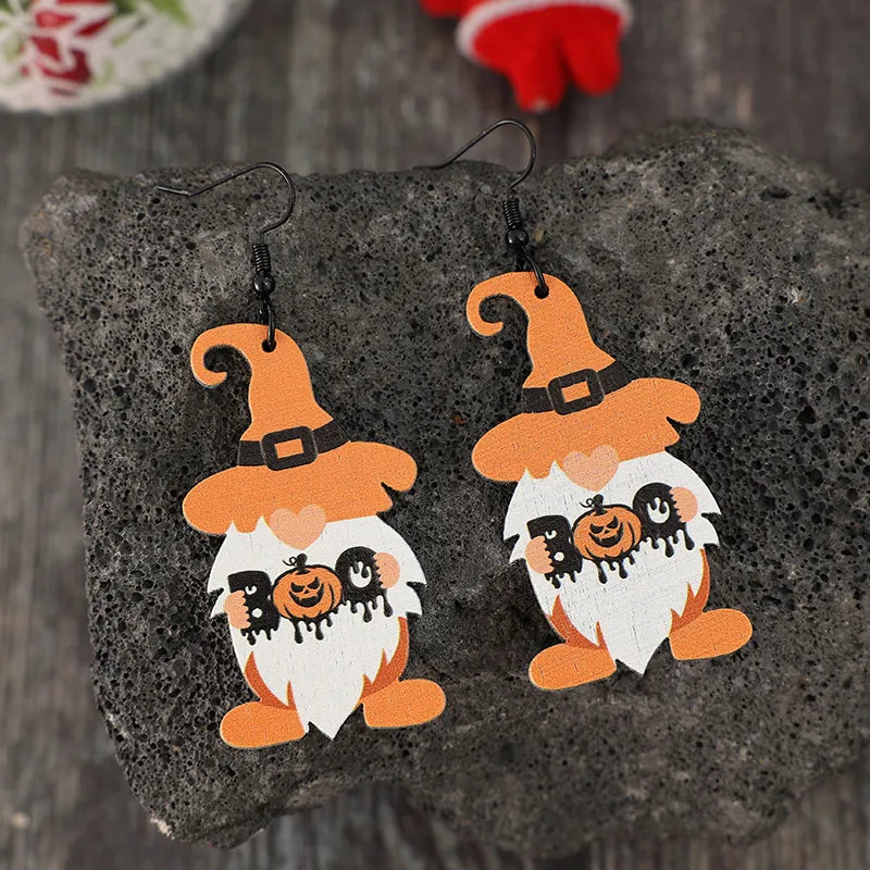 Wooden Dwarfs Pumpkin Dangle Earrings with carved details, hanging from silver hooks, perfect for autumn and Halloween accessories.