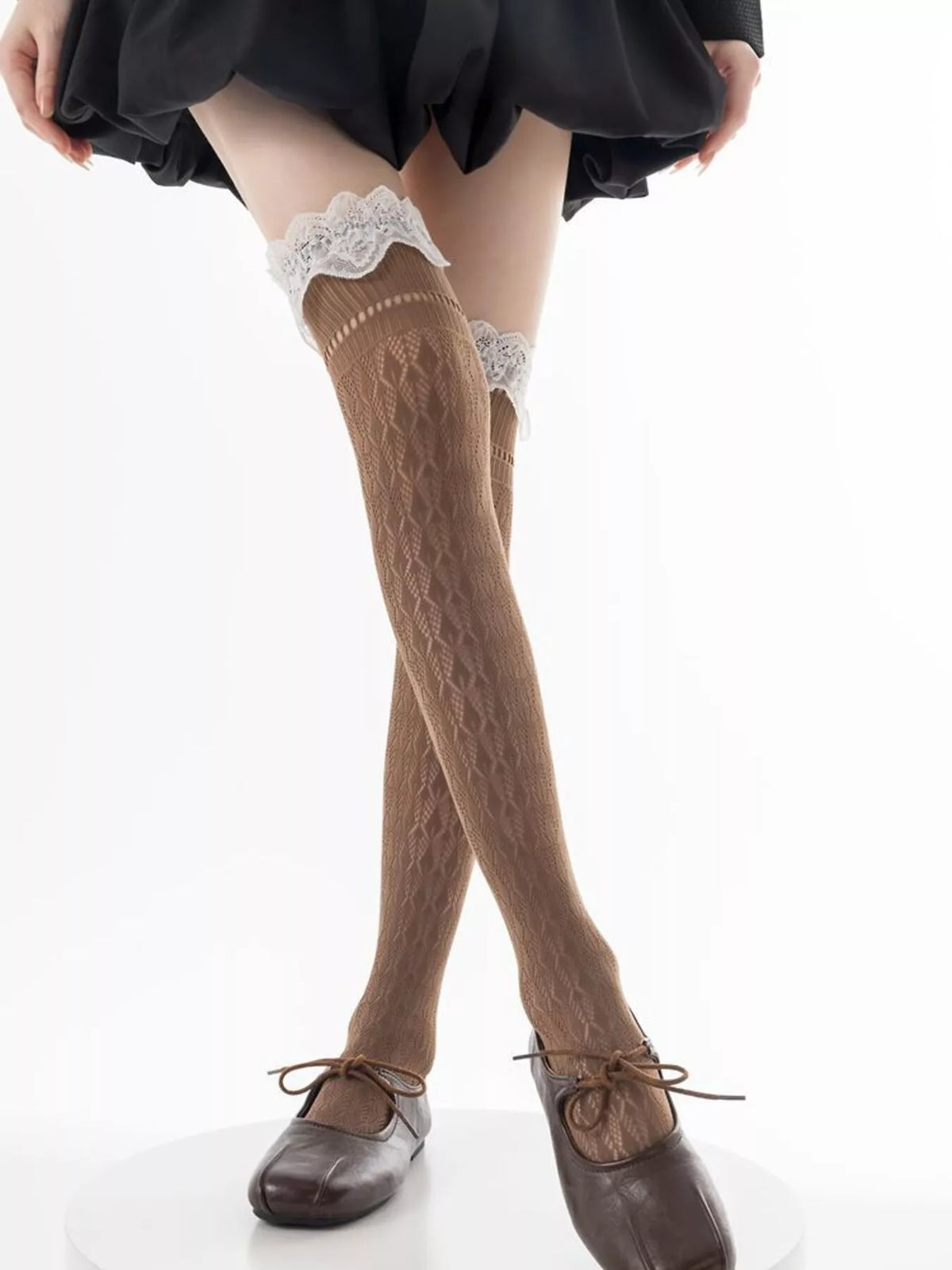 Lace over-the-knee hollow-out stockings by Trendsi featuring intricate lace design and sheer fabric, perfect for stylish legwear.