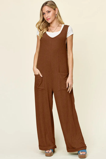 Trendsi Double Take full size sleeveless jumpsuit with textured fabric and wide-leg design, displayed on a hanger.