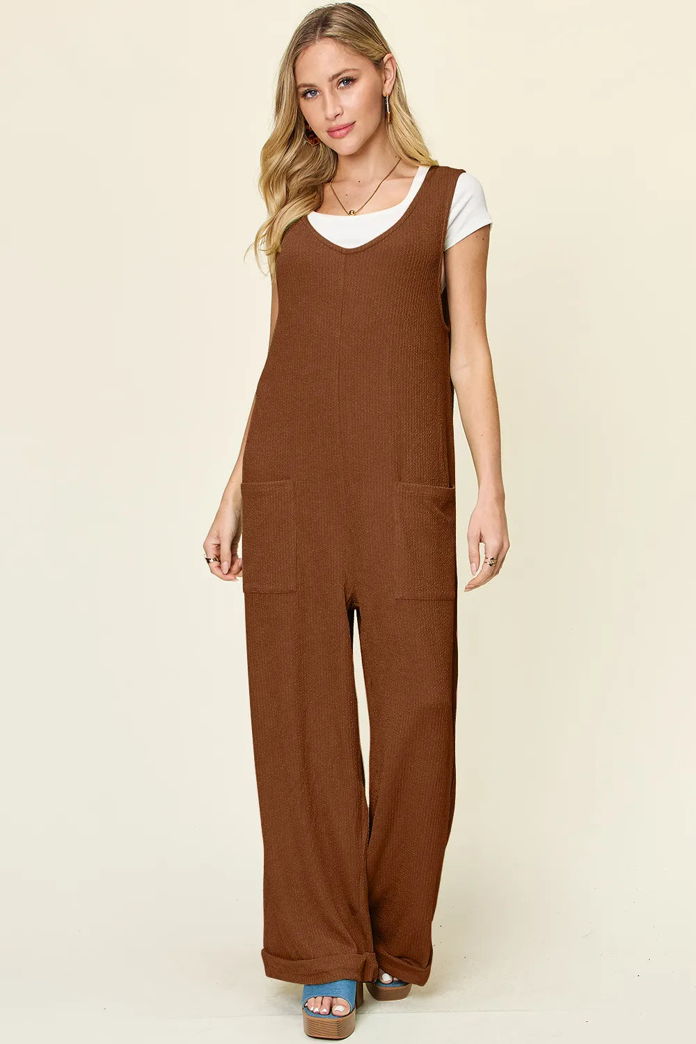 Trendsi Double Take full-size sleeveless jumpsuit with textured fabric, wide-leg design, and sleeveless style, shown on a model.