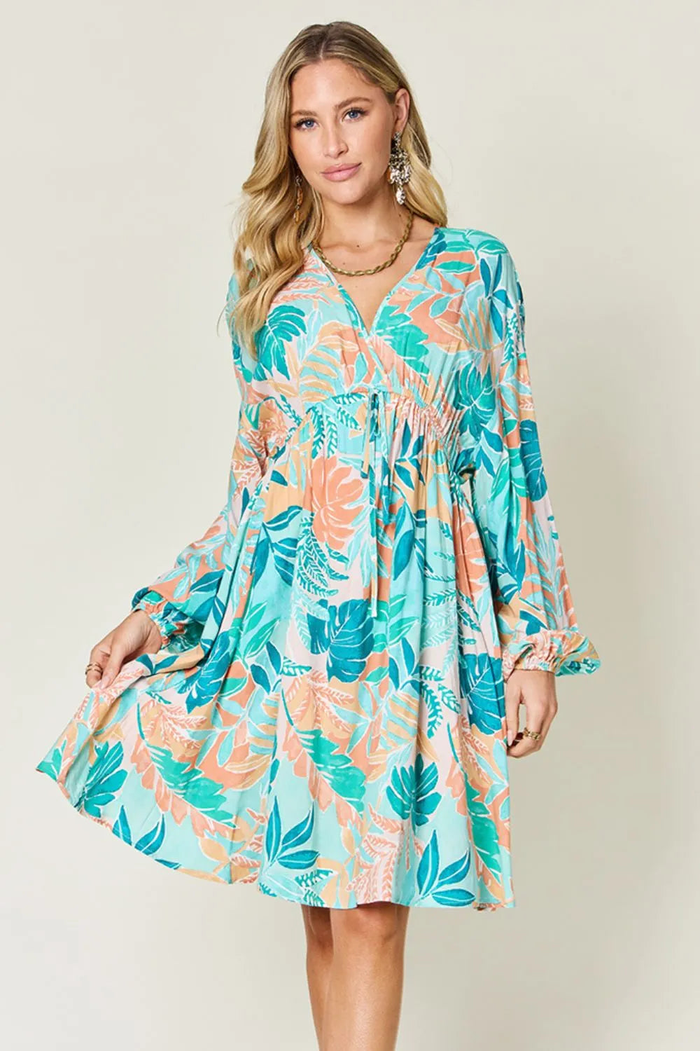 Printed V-neck drawstring dress from Trendsi, featuring a full-size, stylish design with a comfortable fit and eye-catching pattern.