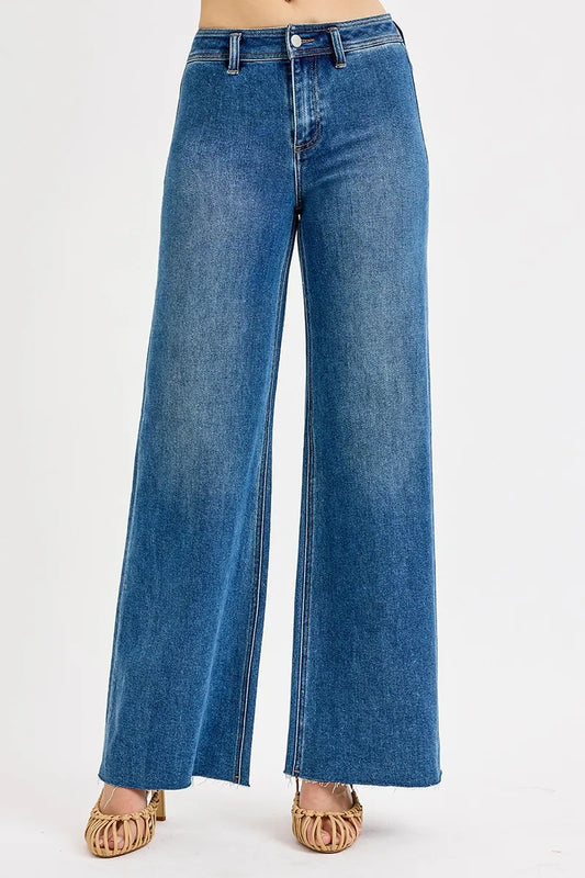 Risen high-waisted wide-leg jeans in denim fabric, displayed on a hanger with a modern, stylish fit.
