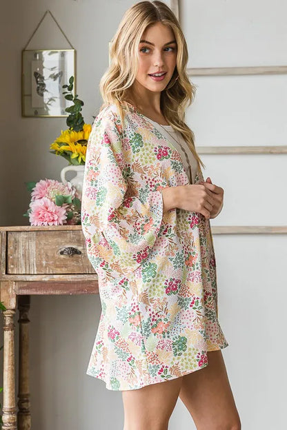 Heimish full size multi-color floral open cardigan, plus size, with vibrant floral pattern and lightweight knit fabric.