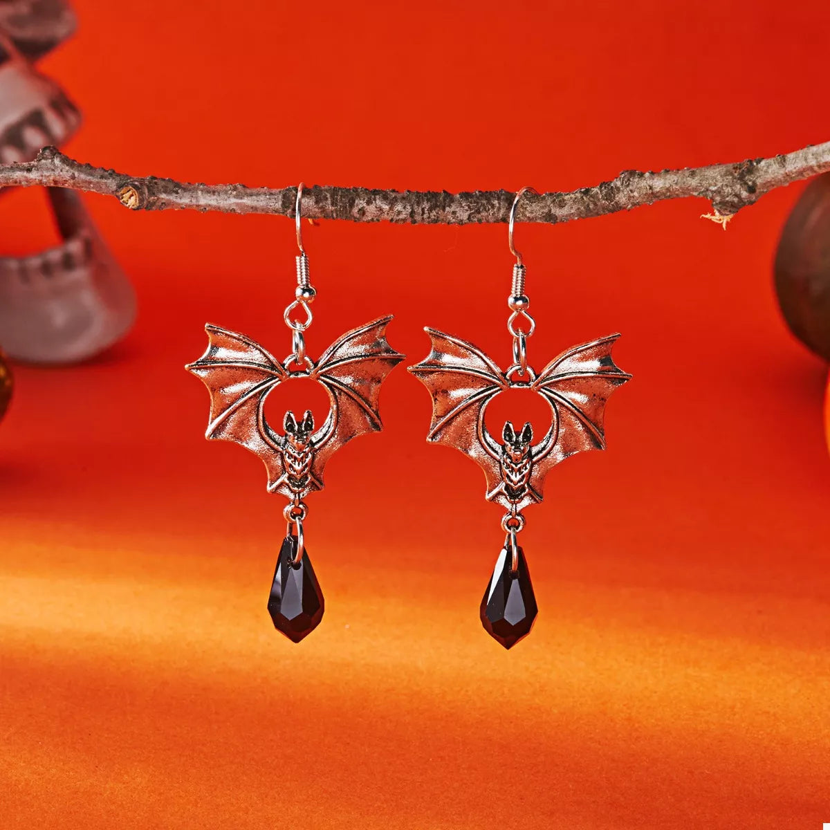 Gothic bat drop earrings featuring black metal bats with detailed wings, hanging from silver hooks, stylish for gothic fashion.