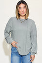 Basic Bae ribbed round neck long sleeve T-shirt by Trendsi, showing its fitted ribbed fabric and classic round neckline.
