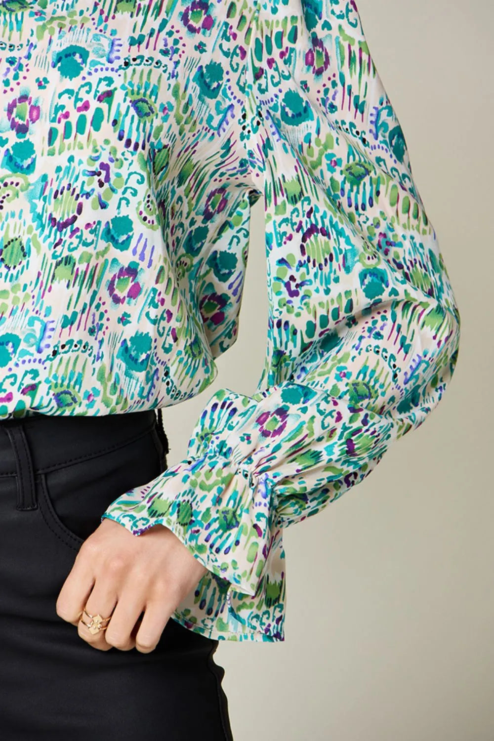 Printed flounce sleeve blouse from Trendsi, featuring a stylish full-size design with vibrant patterns and flowy fabric.