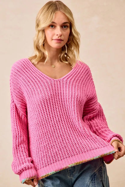 BiBi V-Neck Sweater by Trendsi featuring a colorful trim and soft knit fabric, shown on a model in a casual fashion setting.