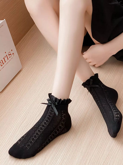 White lace bow socks from Trendsi featuring delicate lace details and a charming bow accent on the ankle.