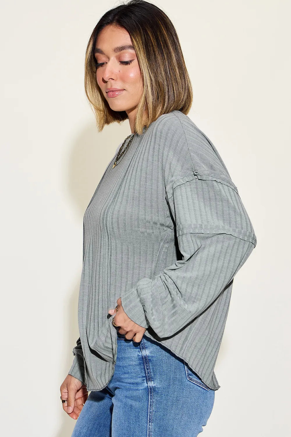 Basic Bae full size ribbed round neck long sleeve T-shirt by Trendsi, shown in black with ribbed texture and fitted long sleeves.