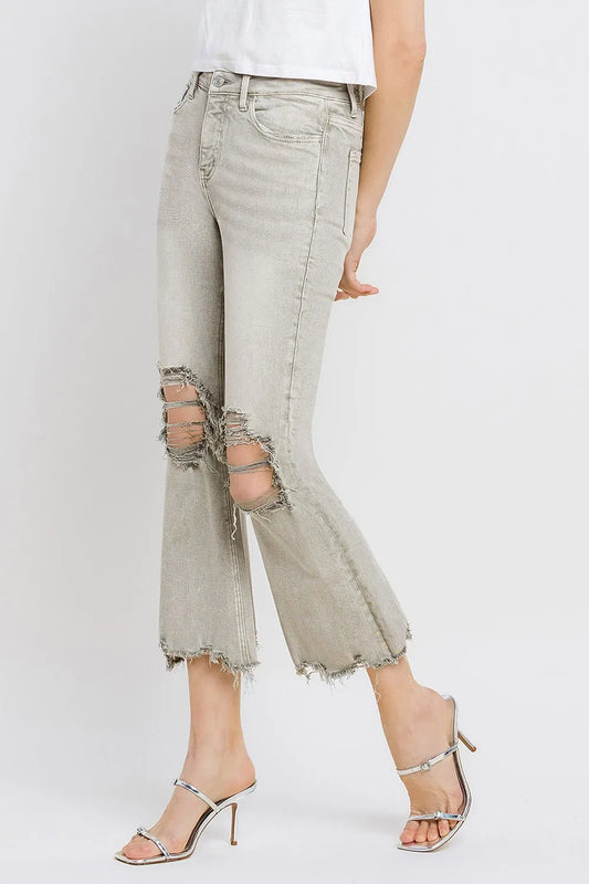 Trendsi Lovervet distressed raw hem cropped flare jeans with frayed edges and a high-waisted fit, shown on a model.
