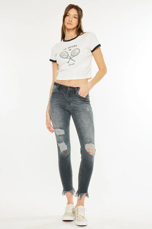 Kancan high-rise distressed ankle skinny jeans with frayed hems and distressed details, fitted silhouette in classic denim blue.