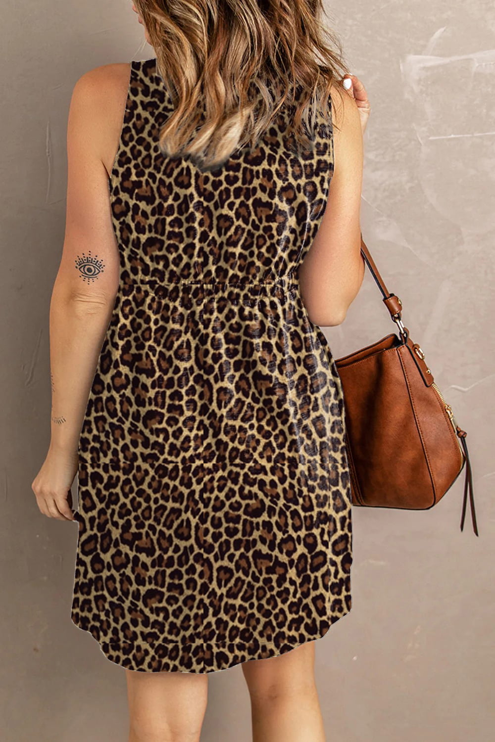 Printed sleeveless casual dress by Trendsi featuring front buttons, ruched waist, side slit, and pockets in a stylish design.