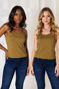 Plus size basic Bae full-size round neck slim cami by Trendsi, shown in black on a model, highlighting its fitted, sleeveless design.