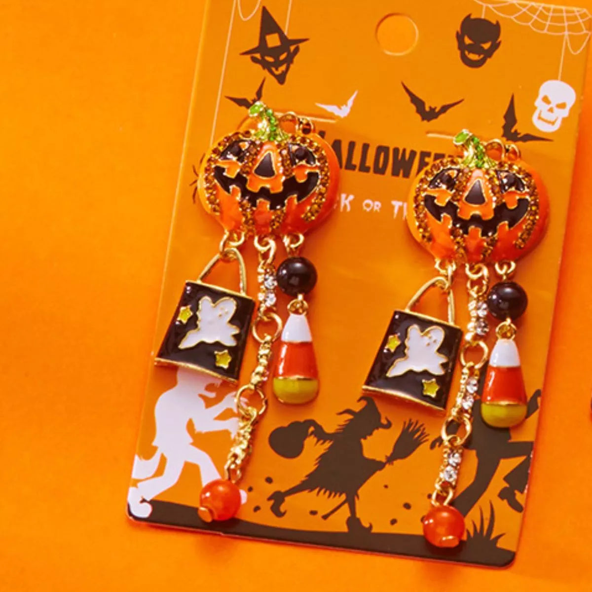 Halloween pumpkin drop earrings featuring orange and black pumpkin charms, perfect for spooky seasonal accessories.