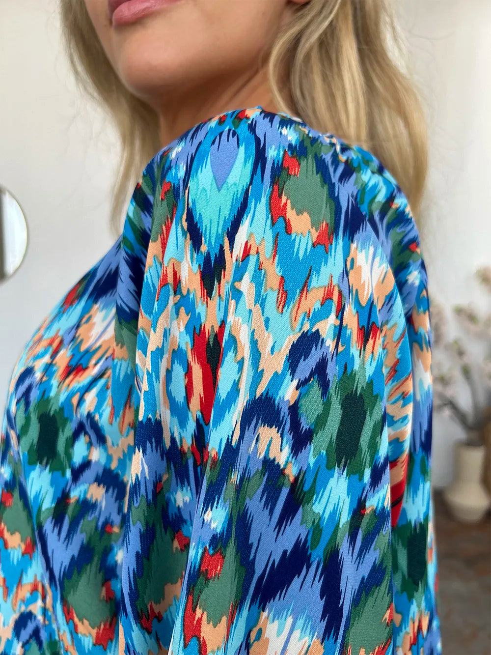 Printed balloon sleeve blouse with double take design, featuring full size fit and trendy style, by Trendsi.