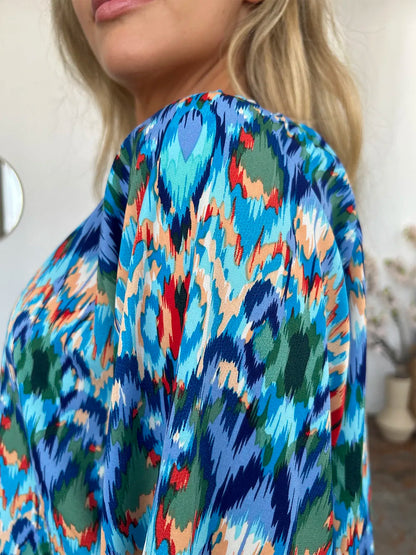 Printed balloon sleeve blouse with double take design, featuring full size fit and trendy style, by Trendsi.