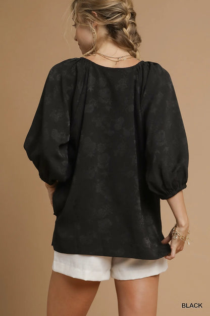 Umgee satin jacquard balloon sleeve blouse from Trendsi, featuring elegant design and intricate fabric pattern.