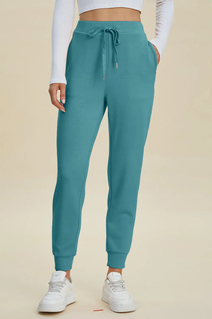 Black high-waist joggers with drawstring, full size Air Scuba Basic Bae joggers by Trendsi, featuring a relaxed fit and comfortable style.