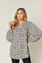 Plus size leopard print long sleeve blouse by Trendsi, featuring a stylish double take full size design with a relaxed fit.