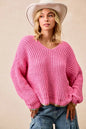 BiBi V-neck sweater by Trendsi featuring colorful trim and soft knit fabric, shown in a close-up of the neckline and trim details.