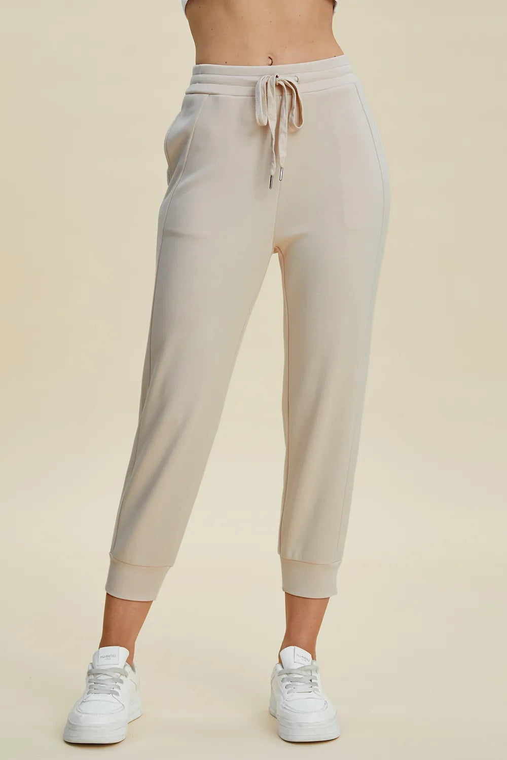 Trendsi Basic Bae full-size air scuba cropped pants with high waist and drawstring, in black fabric, styled for casual wear.