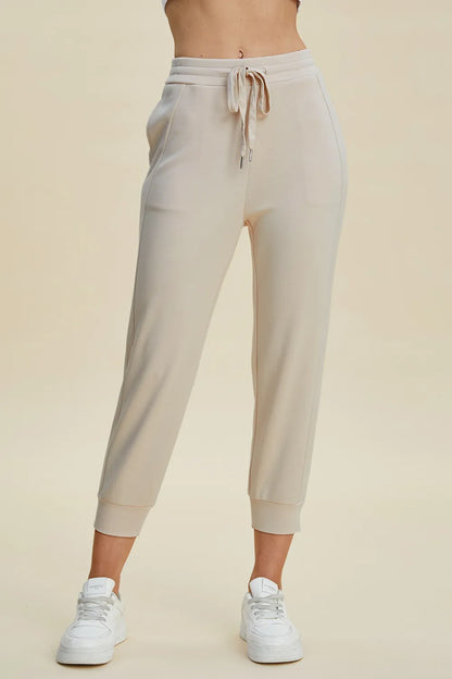 Trendsi Basic Bae full-size air scuba cropped pants with high waist and drawstring, in black fabric, styled for casual wear.