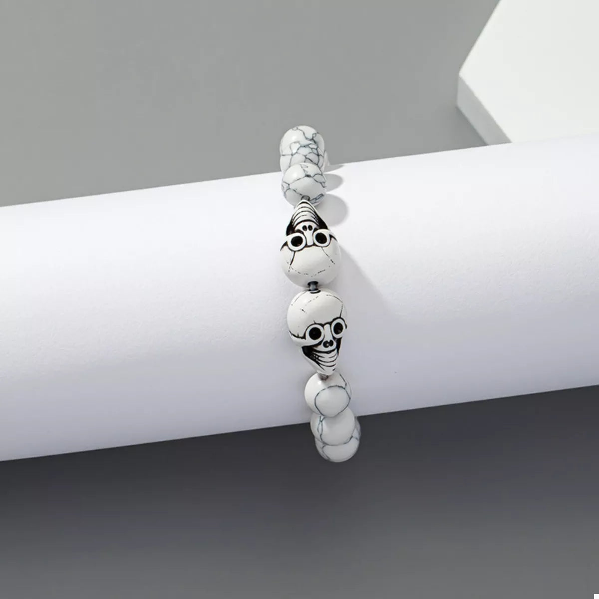 Halloween Skull Beaded Bracelet by Trendsi featuring black and white skull beads on a stretchy elastic band.