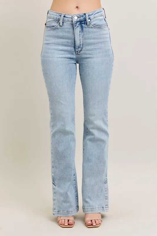 Plus size Judy Blue vintage wash boot jeans with side slits and tummy control, featuring slim fit and stylish design.