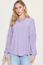 Trendsi Basic Bae full-size ribbed long sleeve T-shirt with round neckline in black, showing the fitted ribbed fabric and long sleeves.