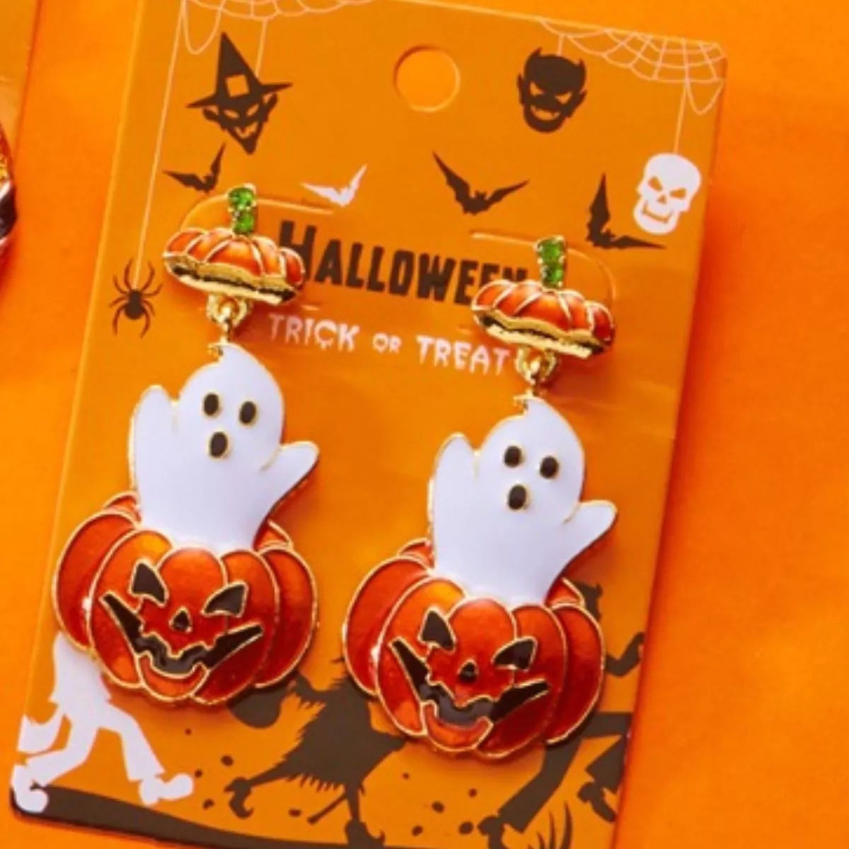 Halloween ghost and pumpkin dangle earrings by Trendsi featuring spooky ghost and pumpkin charms on silver hooks