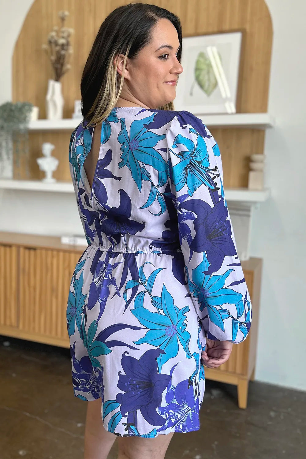 Full size floral long sleeve romper with pockets by Trendsi, featuring a stylish design and comfortable fit.