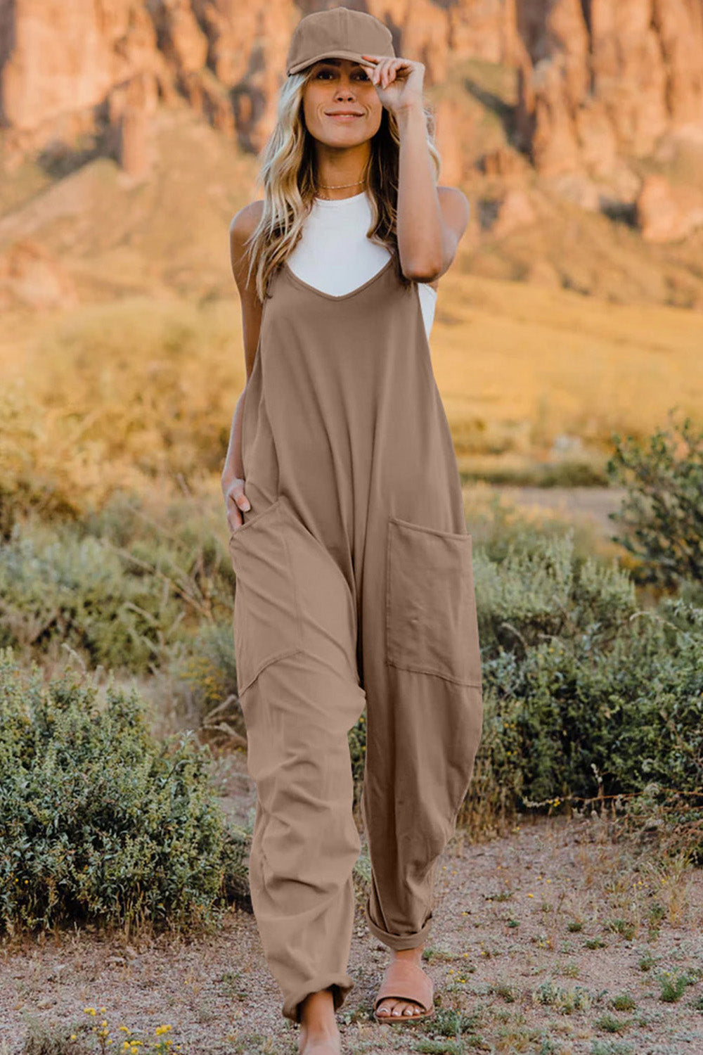 Trendsi Double Take full-size sleeveless v-neck jumpsuit with pockets, shown hanging on a mannequin.