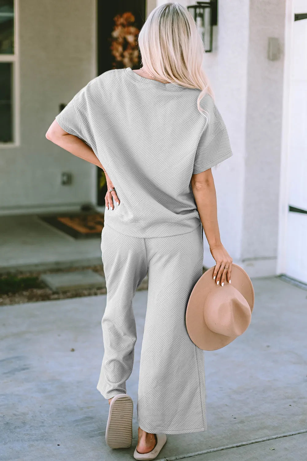 Trendsi Double Take full size textured short sleeve top and matching pants set, stylish and comfortable outfit for everyday wear.