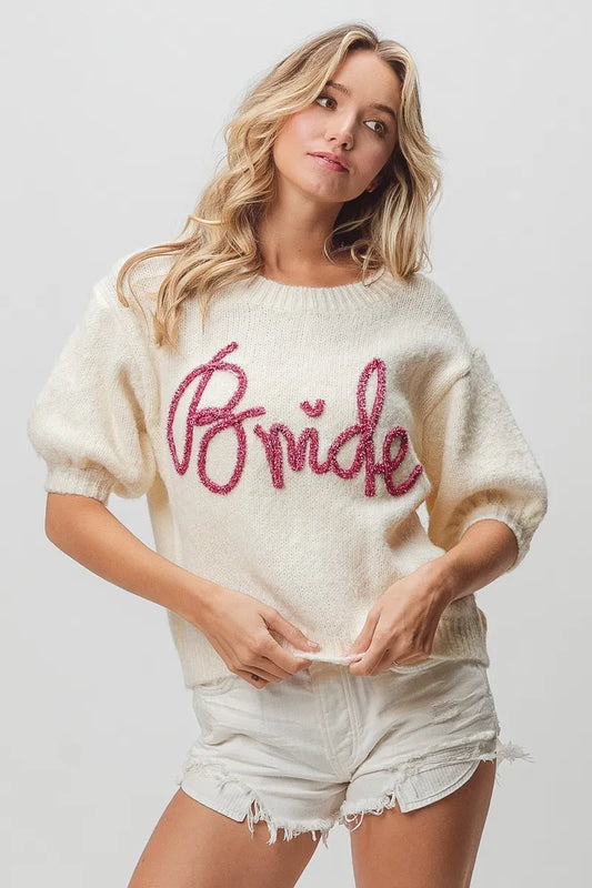 Metallic letter short puff sleeve hairy sweater by Trendsi, featuring a shiny finish and cozy, textured fabric with puffed sleeves.