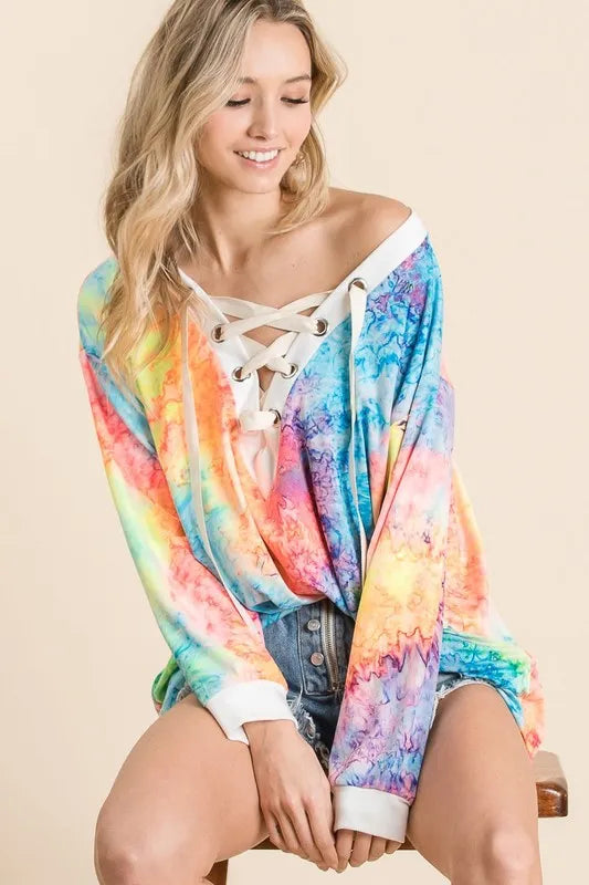 BiBi Tie Dye deep V-neck top with lace-up front, featuring vibrant colors and a trendy, casual style.