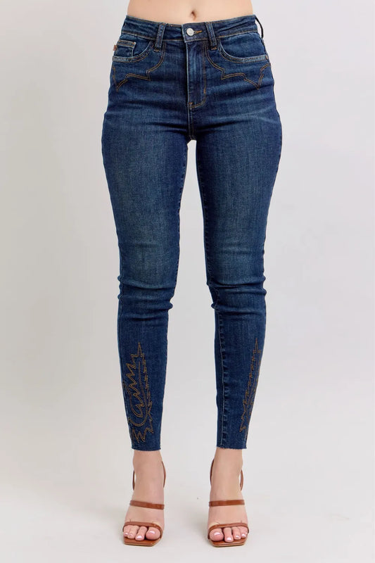 Plus size Judy Blue embroidered high-rise skinny jeans with a fitted silhouette and detailed embroidery on the legs.
