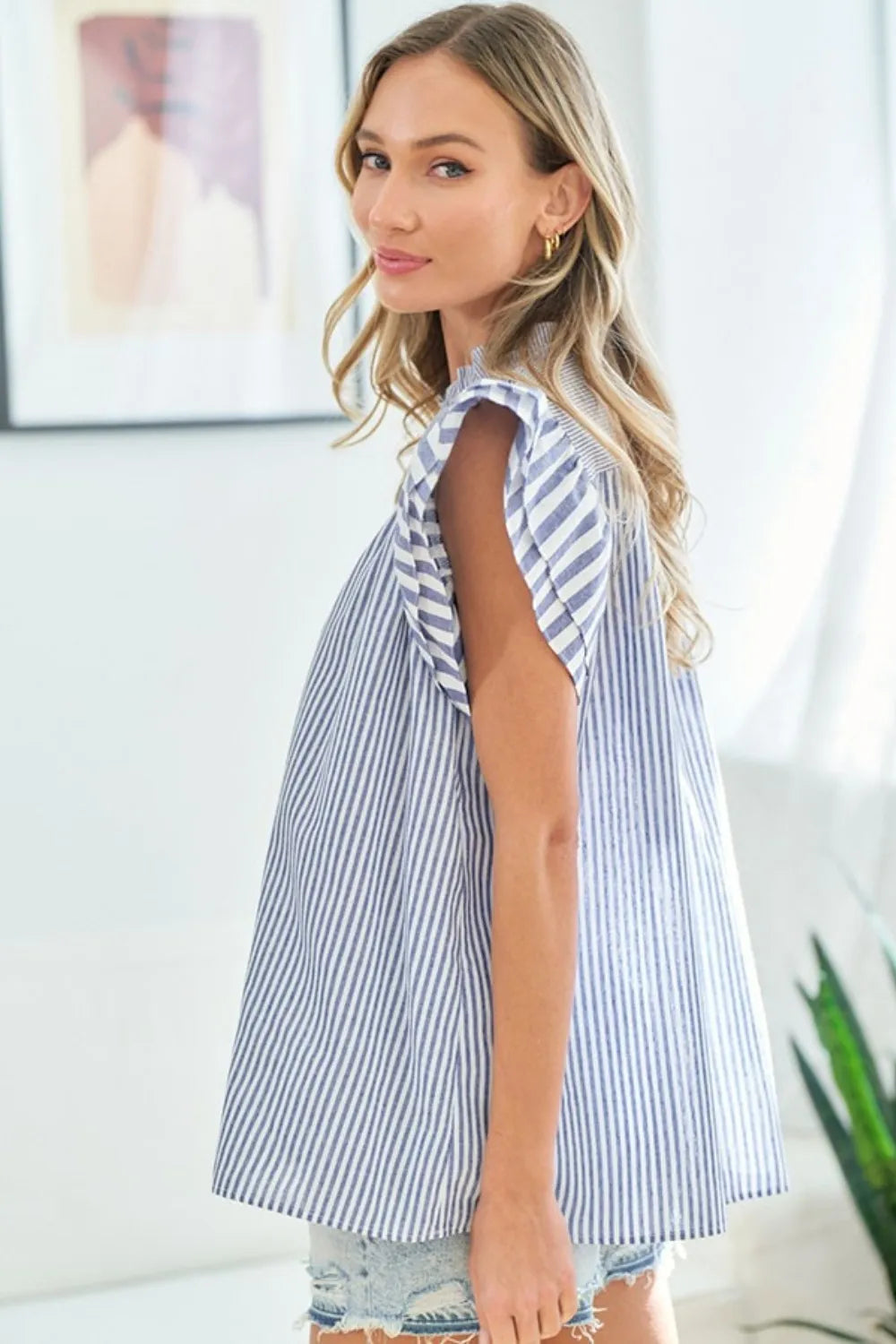 First Love striped flutter sleeve blouse by Trendsi with a relaxed fit and colorful vertical stripes.