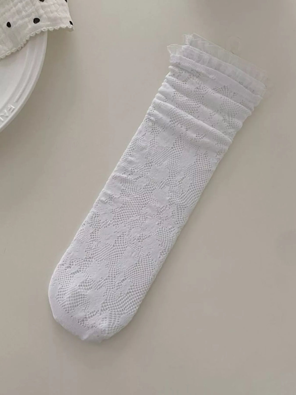 Lace fishnet mid-calf socks from Trendsi featuring intricate lace pattern and classic fishnet design for stylish legwear.