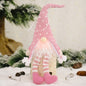 Faceless gnome with long legs and light-up feature, decorative Trendsi garden figurine on a natural outdoor background.