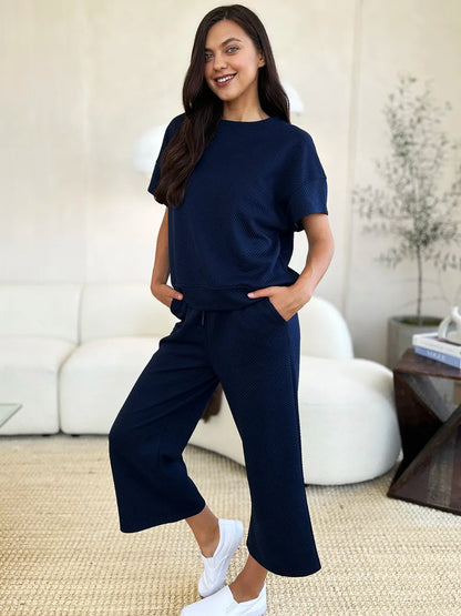 Trendsi Double Take full size textured short sleeve top and matching pants set, stylish and comfortable outfit for casual wear.