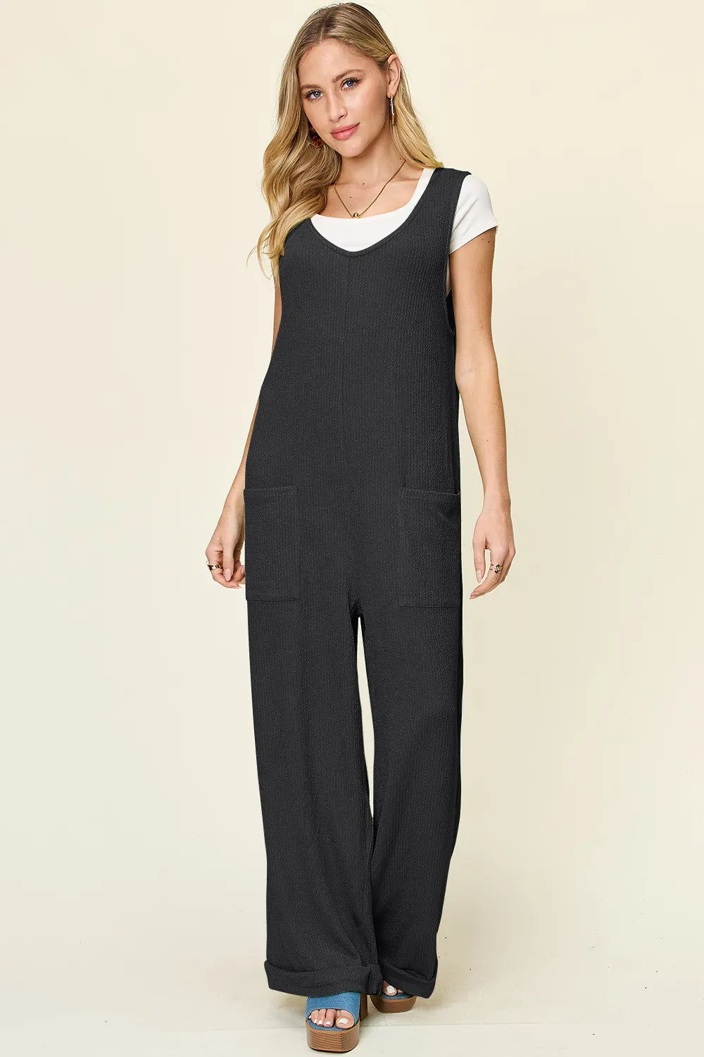 Trendsi Double Take full size sleeveless jumpsuit with textured fabric and wide-leg style, displayed on a hanger.